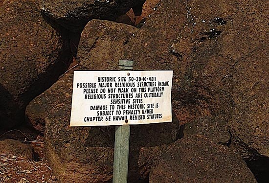 A warning sign protects the heap of ruins.