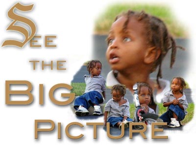 A picture of a cute four-year-old sitting in the grass.