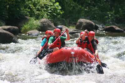People in boat navigating rough waters